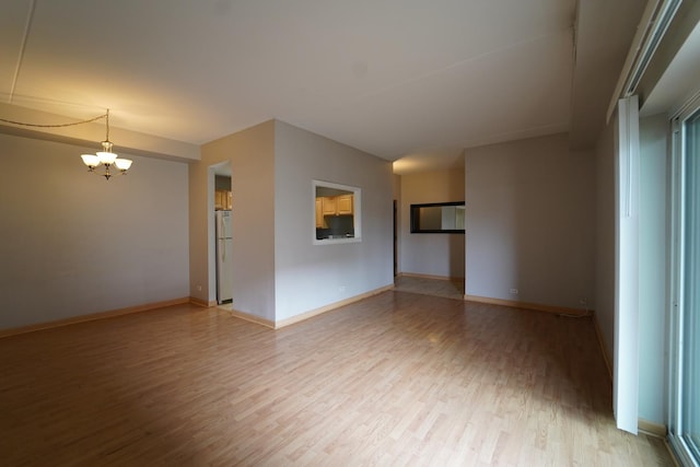 1460 Fairlane Dr Unit 119, Schaumburg, IL 60193 - unfurnished room featuring a chandelier and light wood-style floors