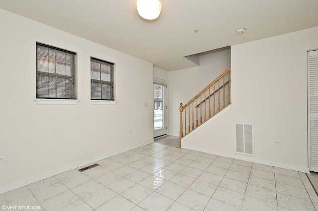 2321 S Wabash Ave Unit 12, Chicago, IL 60616 - spare room with stairs, light tile patterned floors, a smoke detector, and a pendent fire sprinkler