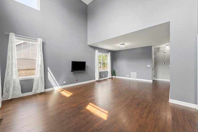 802 Barton Dr, Oswego, IL 60543 - unfurnished living room with a towering ceiling and wood finished floors