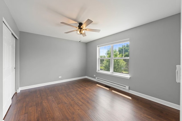 802 Barton Dr, Oswego, IL 60543 - unfurnished bedroom with baseboard heating, a closet, dark wood-type flooring, and ceiling fan