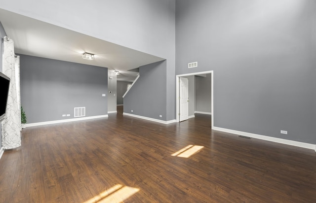 802 Barton Dr, Oswego, IL 60543 - unfurnished living room featuring wood finished floors, a fireplace, and a high ceiling