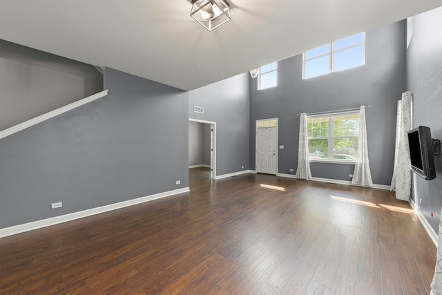 802 Barton Dr, Oswego, IL 60543 - unfurnished living room featuring wood finished floors and a high ceiling