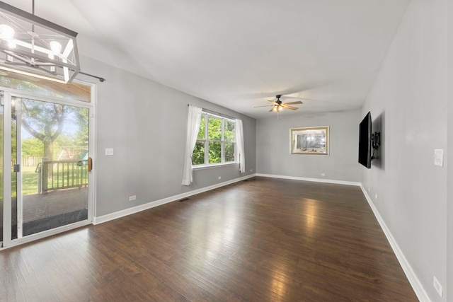 802 Barton Dr, Oswego, IL 60543 - unfurnished room featuring dark wood finished floors, ceiling fan, and a chandelier