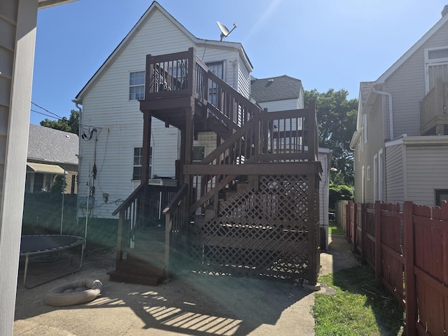 6646 S Wabash Ave, Chicago, IL 60637 - back of property with a trampoline, stairs, and a deck