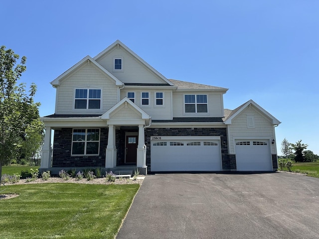 25805 W Springside St, Plainfield, IL 60586 - craftsman-style house featuring driveway, an attached garage, a front yard, and stone siding