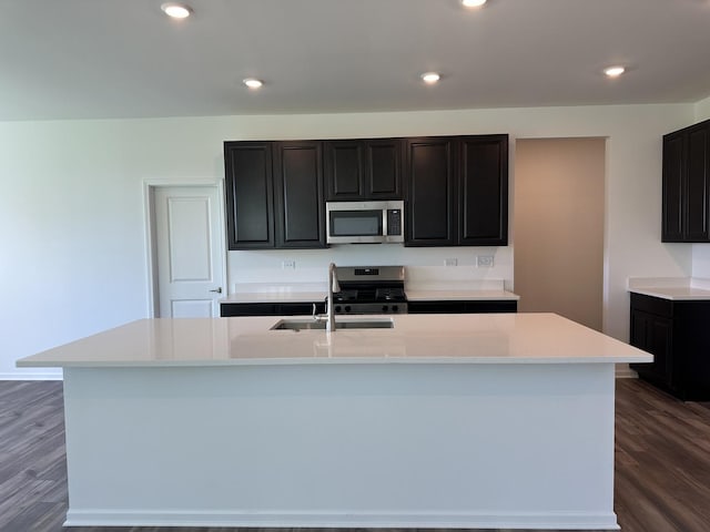 25805 W Springside St, Plainfield, IL 60586 - kitchen with stainless steel appliances, an island with sink, light countertops, dark wood-type flooring, and recessed lighting