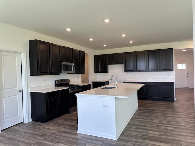 25805 W Springside St, Plainfield, IL 60586 - kitchen featuring appliances with stainless steel finishes, dark wood-style floors, an island with sink, recessed lighting, and light countertops