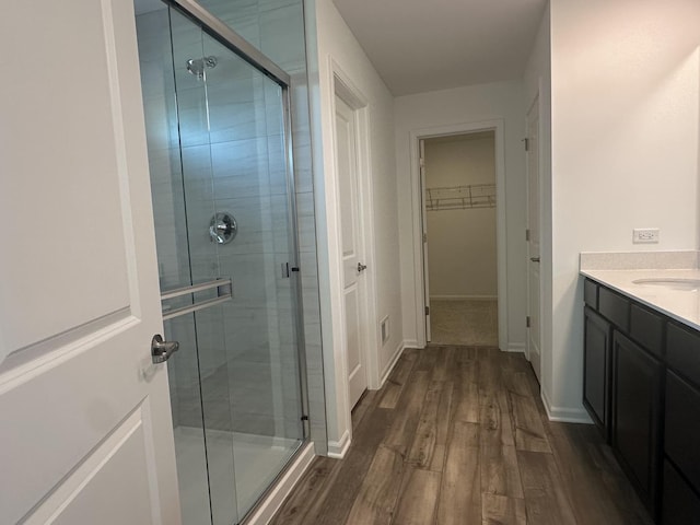 25805 W Springside St, Plainfield, IL 60586 - bathroom with a stall shower, wood finished floors, vanity, and a spacious closet