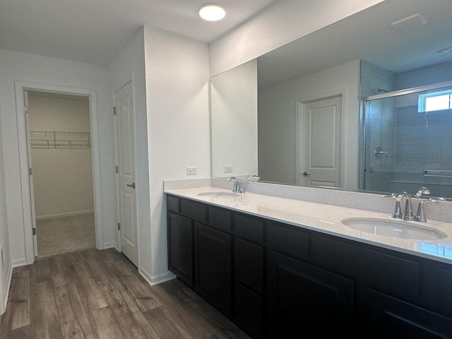 25805 W Springside St, Plainfield, IL 60586 - full bathroom featuring a shower stall, double vanity, wood finished floors, and a spacious closet