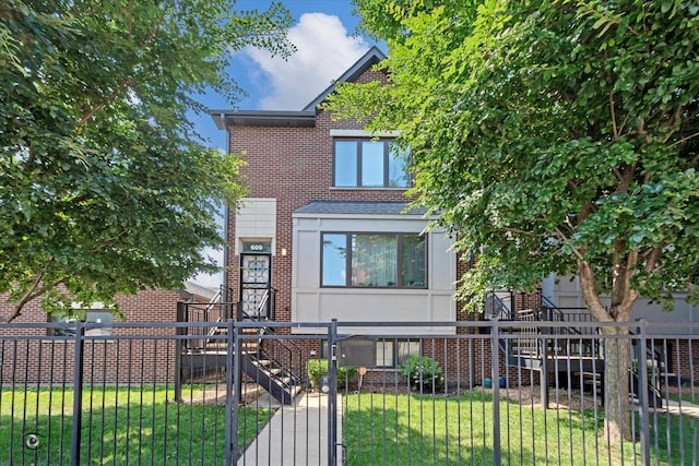 609 E 48th St, Chicago, IL 60615 - view of front of property featuring a fenced front yard, brick siding, stucco siding, and a gate
