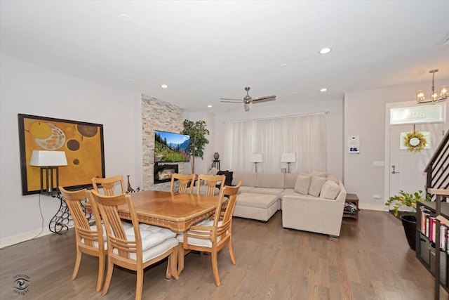 609 E 48th St, Chicago, IL 60615 - dining space featuring wood finished floors, a stone fireplace, recessed lighting, a chandelier, and a ceiling fan