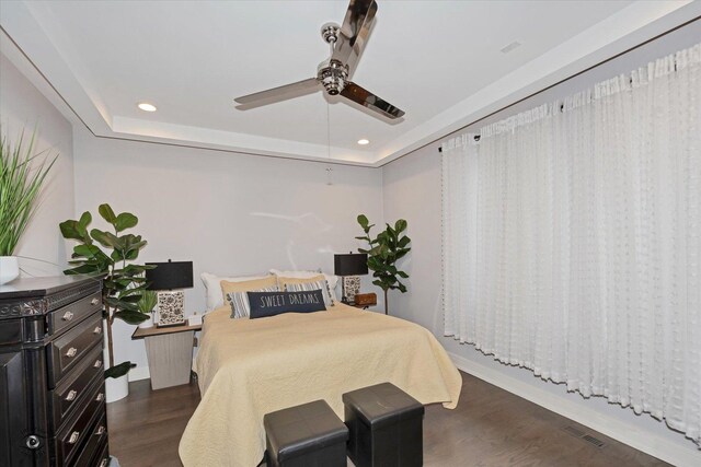 609 E 48th St, Chicago, IL 60615 - bedroom with dark wood-style floors, recessed lighting, a tray ceiling, and a ceiling fan