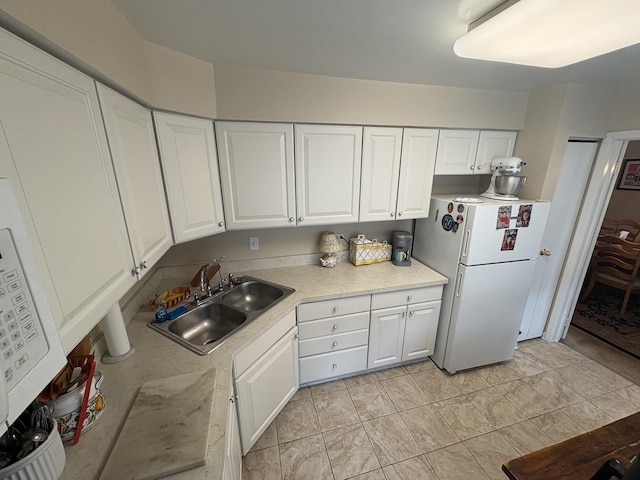 701 Ridge Rd Unit 1D, Wilmette, IL 60091 - kitchen featuring freestanding refrigerator, white cabinets, and light countertops