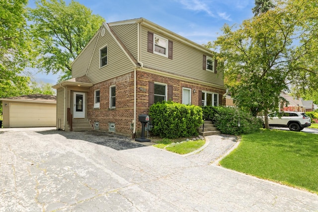 235 S Warrington Rd, Des Plaines, IL 60016 - view of front facade featuring entry steps, brick siding, a front yard, a detached garage, and an outbuilding