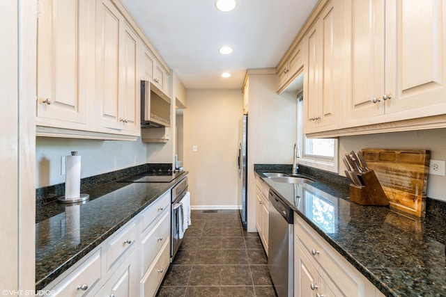 235 S Warrington Rd, Des Plaines, IL 60016 - kitchen featuring stainless steel appliances, recessed lighting, dark tile patterned floors, and dark stone countertops