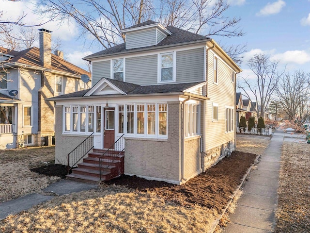 150 N Raynor Ave, Joliet, IL 60435 - american foursquare style home with entry steps, brick siding, and a shingled roof