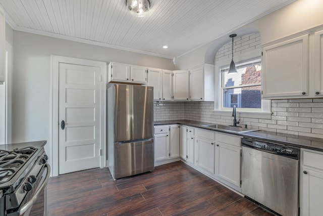 150 N Raynor Ave, Joliet, IL 60435 - kitchen featuring stainless steel appliances, dark countertops, crown molding, white cabinets, and tasteful backsplash