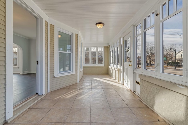 150 N Raynor Ave, Joliet, IL 60435 - unfurnished sunroom with tile patterned floors, ornamental molding, and arched walkways