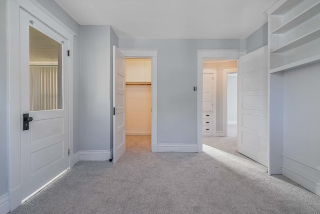 150 N Raynor Ave, Joliet, IL 60435 - unfurnished bedroom featuring carpet, a closet, and a walk in closet
