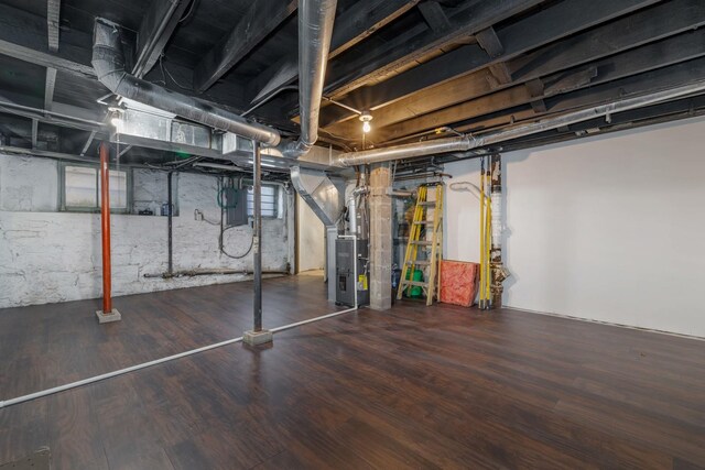 150 N Raynor Ave, Joliet, IL 60435 - unfinished basement with heating unit, wood finished floors, and electric panel
