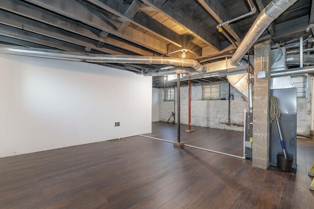 150 N Raynor Ave, Joliet, IL 60435 - below grade area featuring wood finished floors and heating unit