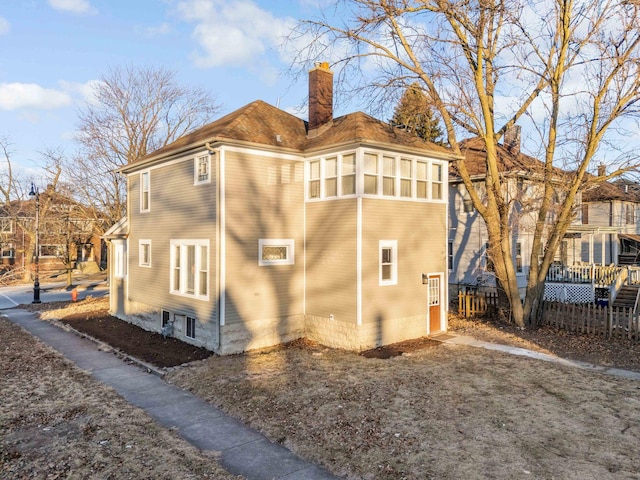 150 N Raynor Ave, Joliet, IL 60435 - view of side of home featuring a chimney