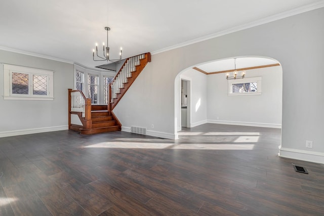 150 N Raynor Ave, Joliet, IL 60435 - unfurnished living room featuring a chandelier, arched walkways, wood finished floors, ornamental molding, and stairs