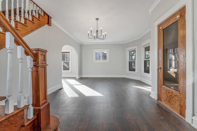 150 N Raynor Ave, Joliet, IL 60435 - unfurnished dining area with dark wood-style flooring, stairway, a chandelier, crown molding, and arched walkways