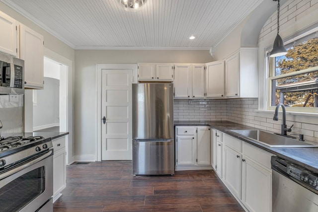 150 N Raynor Ave, Joliet, IL 60435 - kitchen with stainless steel appliances, dark countertops, crown molding, backsplash, and white cabinetry