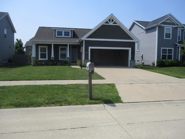 201 Cattail Ave, Savoy, IL 61874 - craftsman house with an attached garage, a front lawn, driveway, and stone siding