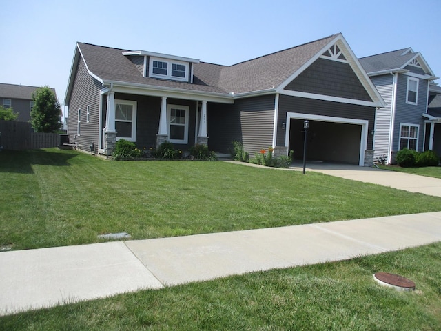 201 Cattail Ave, Savoy, IL 61874 - craftsman-style house with a garage, concrete driveway, a front yard, a shingled roof, and stone siding