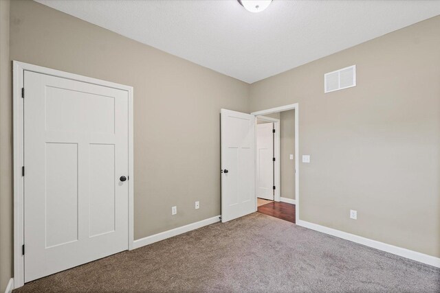 201 Cattail Ave, Savoy, IL 61874 - unfurnished bedroom with carpet flooring and baseboards