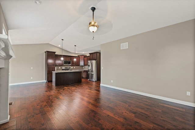 201 Cattail Ave, Savoy, IL 61874 - kitchen with stainless steel appliances, open floor plan, vaulted ceiling, dark brown cabinetry, and ceiling fan