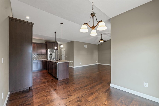201 Cattail Ave, Savoy, IL 61874 - kitchen featuring stainless steel fridge, a chandelier, ceiling fan, dark brown cabinets, and tasteful backsplash