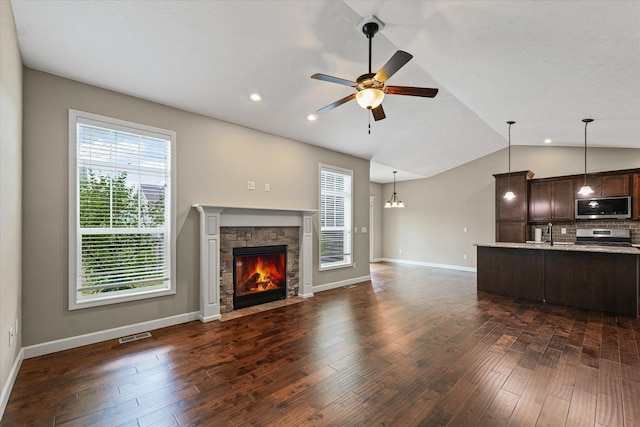 201 Cattail Ave, Savoy, IL 61874 - unfurnished living room with lofted ceiling, ceiling fan, a fireplace, dark wood-style flooring, and recessed lighting