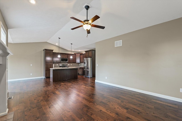 201 Cattail Ave, Savoy, IL 61874 - kitchen with appliances with stainless steel finishes, open floor plan, dark brown cabinetry, ceiling fan, and vaulted ceiling