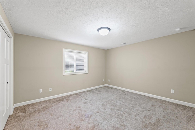 201 Cattail Ave, Savoy, IL 61874 - unfurnished bedroom featuring carpet floors, a closet, and a textured ceiling