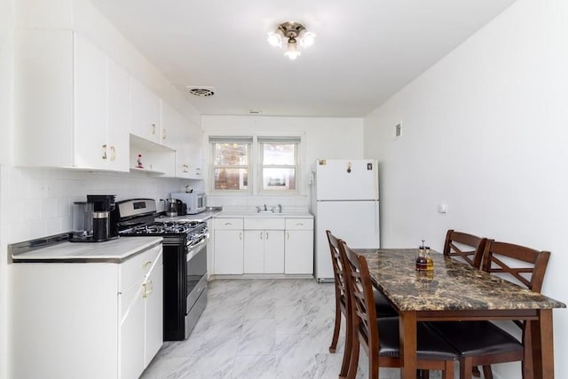 8914 La Crosse Ave Unit 2S, Skokie, IL 60077 - kitchen featuring white appliances, decorative backsplash, white cabinetry, light marble finish flooring, and light countertops