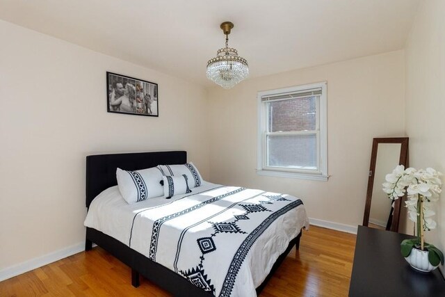 8914 La Crosse Ave Unit 2S, Skokie, IL 60077 - bedroom featuring a chandelier and wood finished floors
