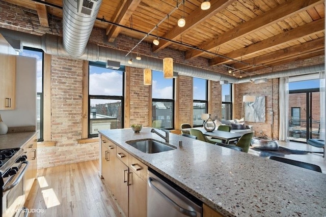2511 W Moffat St Unit 305-D, Chicago, IL 60647 - kitchen featuring stainless steel appliances, brick wall, light wood-type flooring, a wooden ceiling with exposed beams, and light stone counters