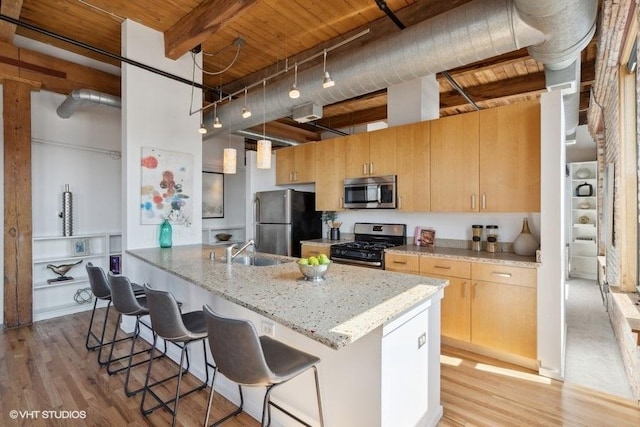 2511 W Moffat St Unit 305-D, Chicago, IL 60647 - kitchen with stainless steel appliances, a wooden ceiling with exposed beams, a kitchen breakfast bar, light stone countertops, and a towering ceiling
