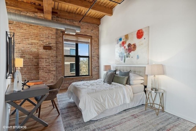 2511 W Moffat St Unit 305-D, Chicago, IL 60647 - bedroom with a wooden ceiling with exposed beams, wood finished floors, and brick wall
