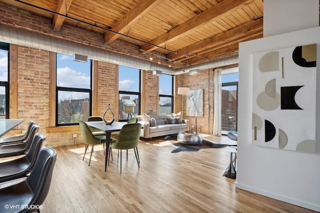 2511 W Moffat St Unit 305-D, Chicago, IL 60647 - dining area featuring a wooden ceiling with exposed beams, wood finished floors, and brick wall