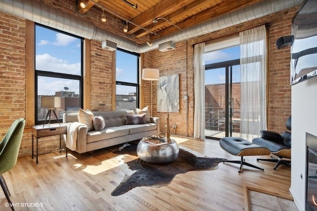 2511 W Moffat St Unit 305-D, Chicago, IL 60647 - living area featuring brick wall, wood finished floors, rail lighting, and wood ceiling