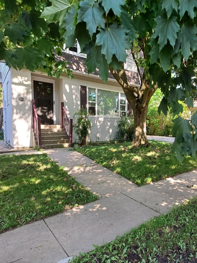 555 Lorraine Ave, Waukegan, IL 60085 - entrance to property featuring stucco siding and a lawn