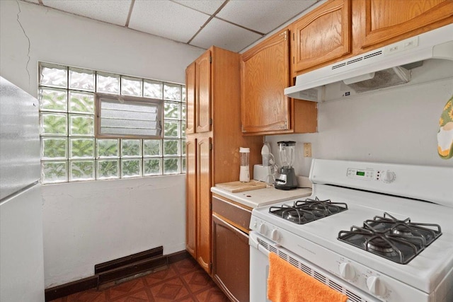 555 Lorraine Ave, Waukegan, IL 60085 - kitchen featuring white appliances, under cabinet range hood, light countertops, and brown cabinetry