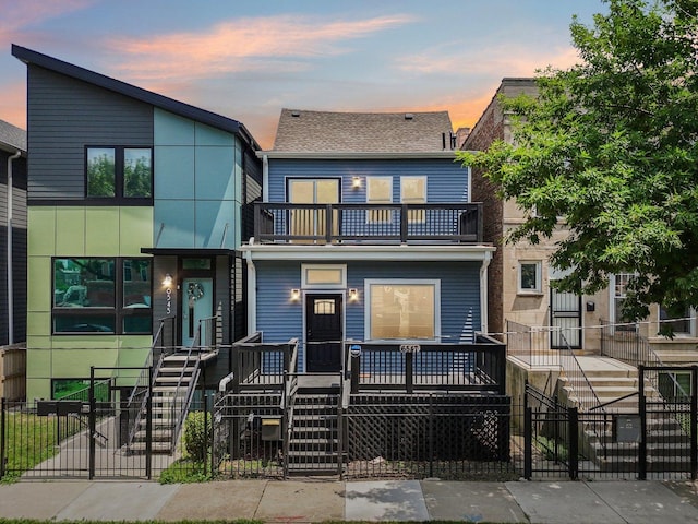6547 S Langley Ave, Chicago, IL 60637 - view of property with a balcony, a fenced front yard, stairs, and a gate