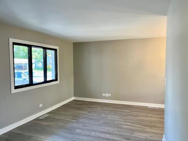 3105 Fox Hill Rd, Aurora, IL 60504 - spare room with dark wood-style flooring and baseboards
