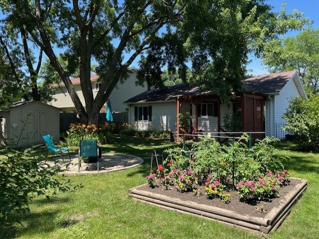 3105 Fox Hill Rd, Aurora, IL 60504 - view of green lawn with a storage shed and a garden