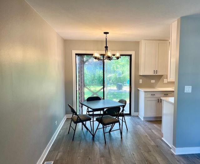 3105 Fox Hill Rd, Aurora, IL 60504 - dining space featuring dark wood-style floors and a chandelier